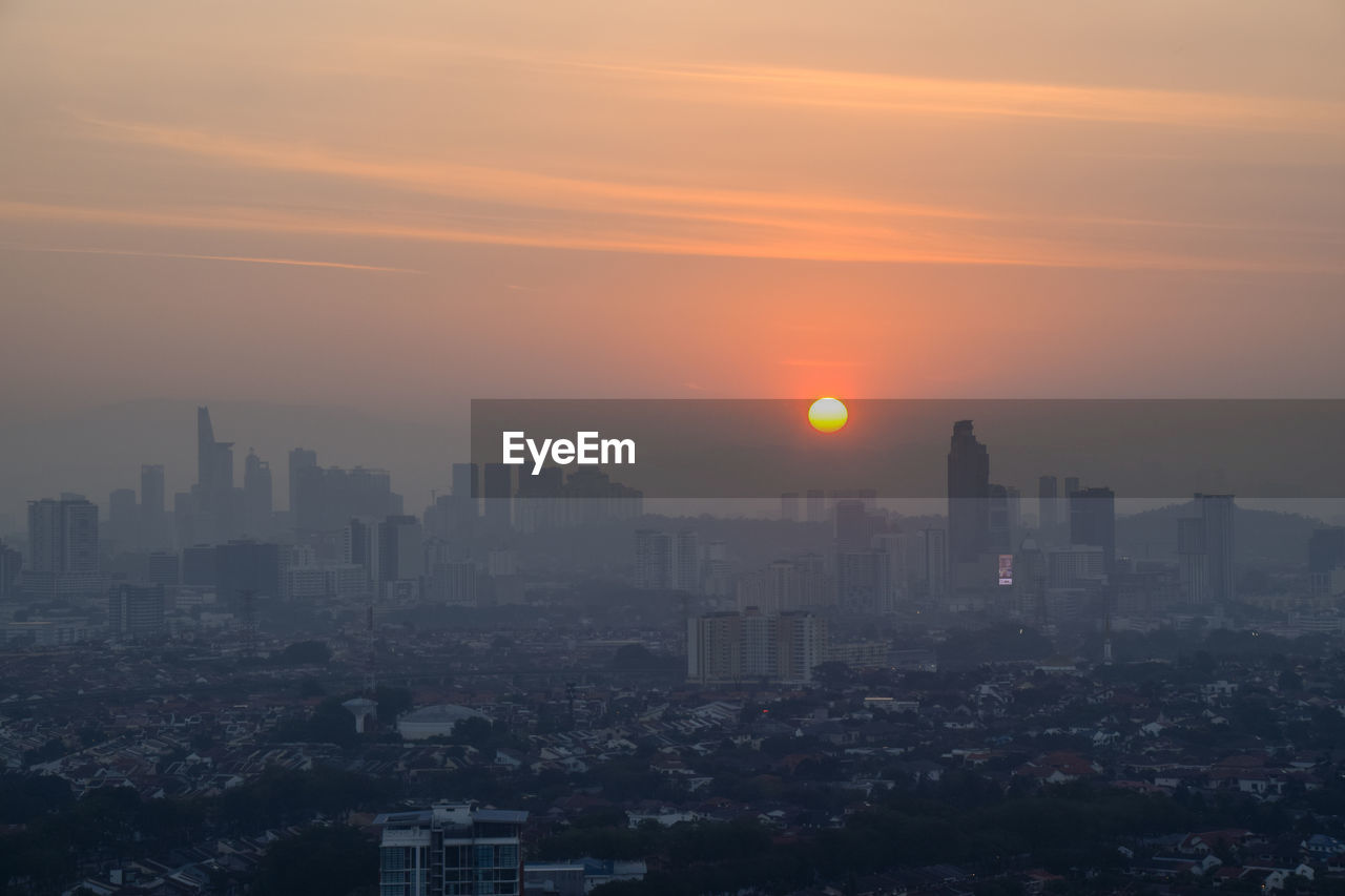 Cityscape against sky during sunset