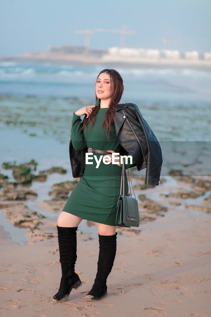 WOMAN STANDING ON BEACH