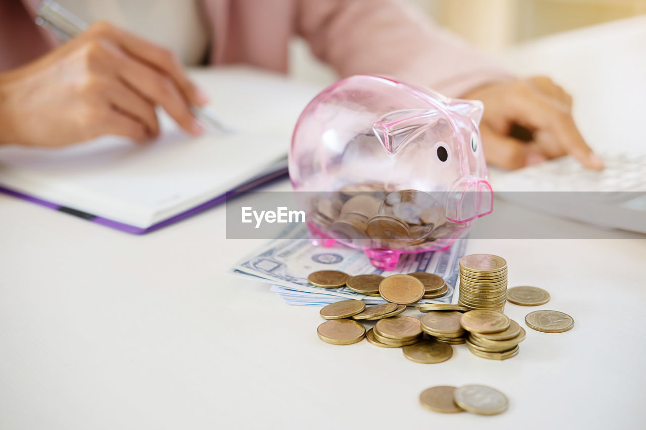 Midsection of business person counting money in office