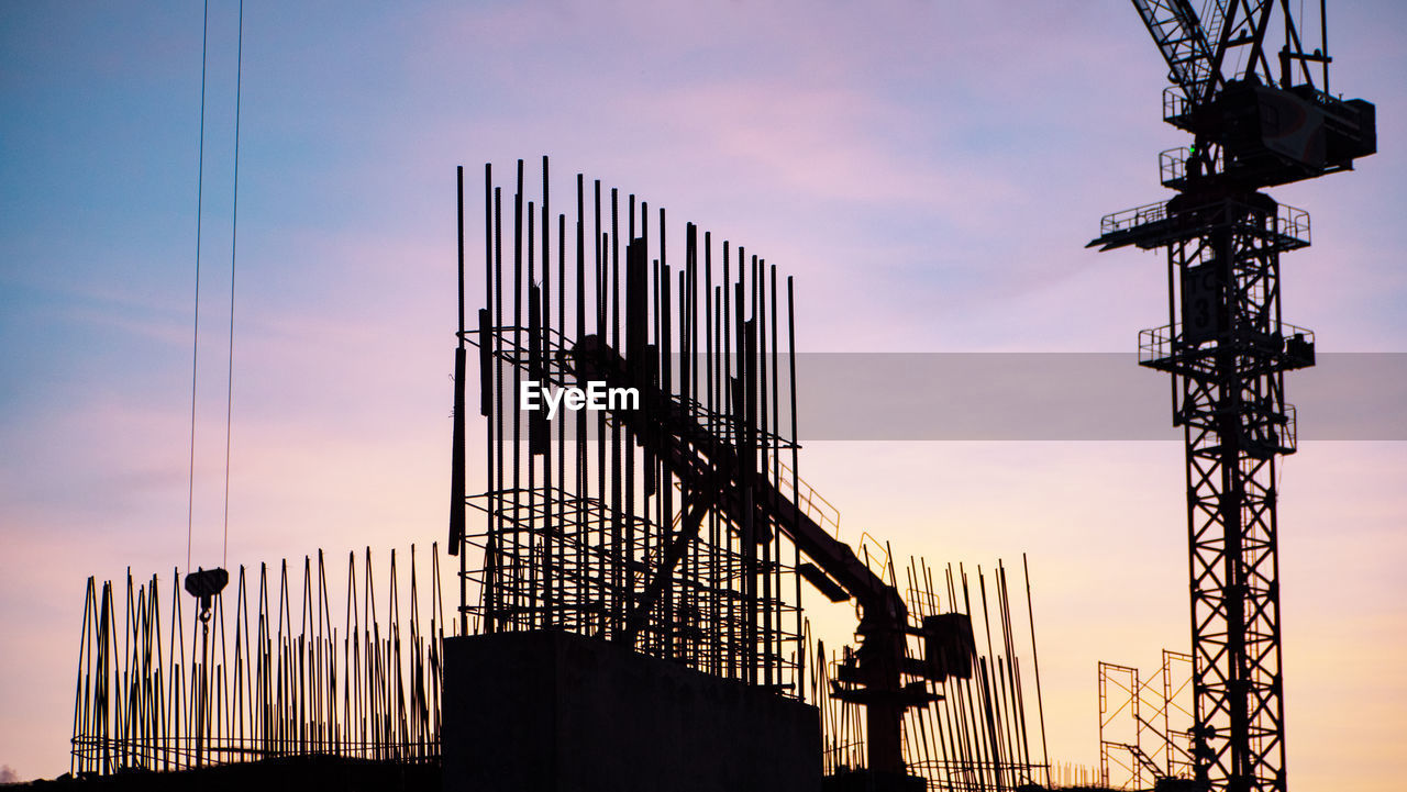 LOW ANGLE VIEW OF SILHOUETTE CRANE AGAINST SKY