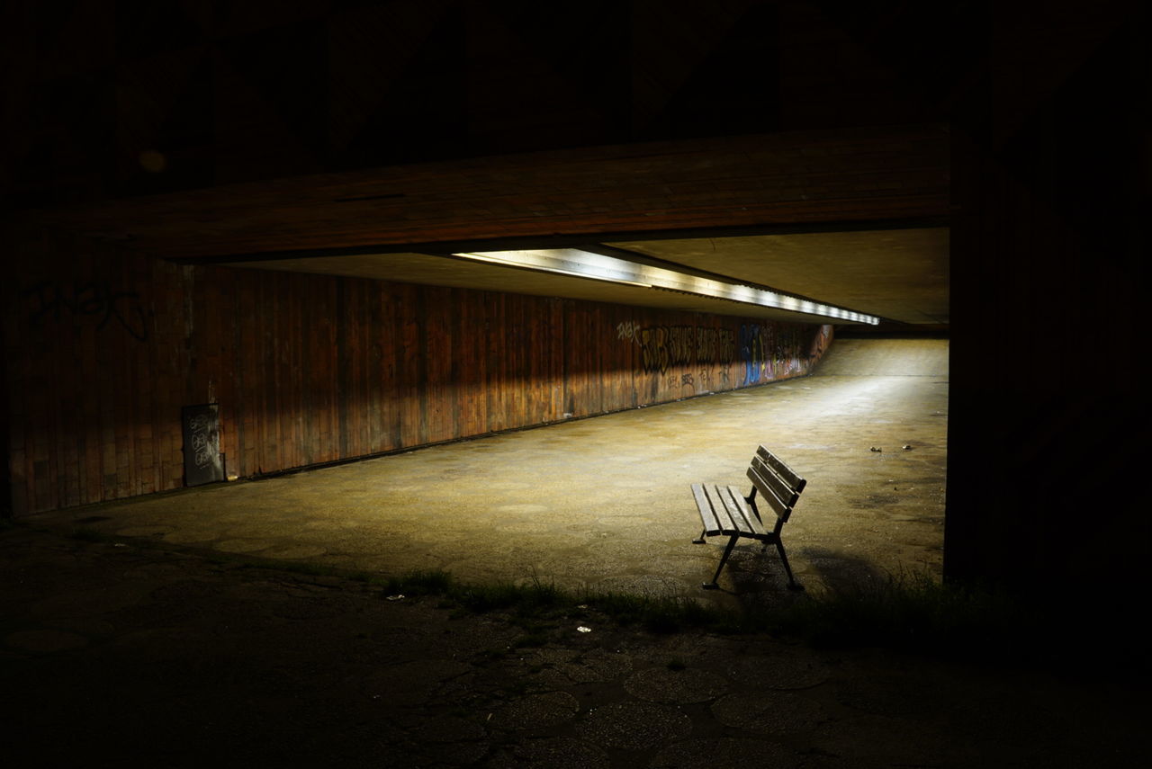 Empty bench in tunnel