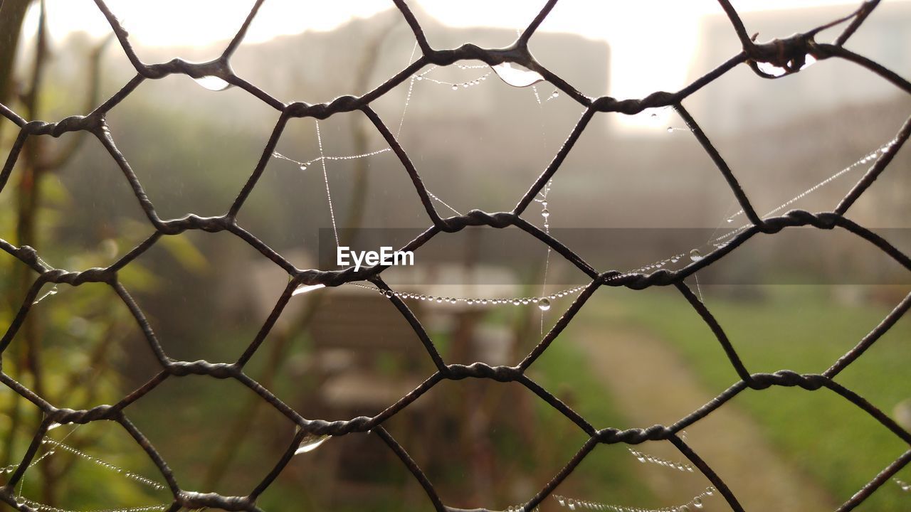 Full frame shot of field seen through chainlink fence