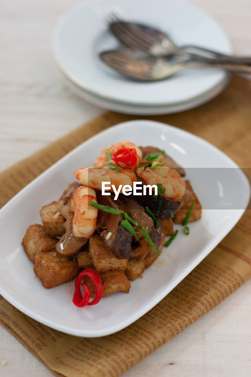 High angle view of stir fried tofu and shrimp with sweet soy sauce served in plate