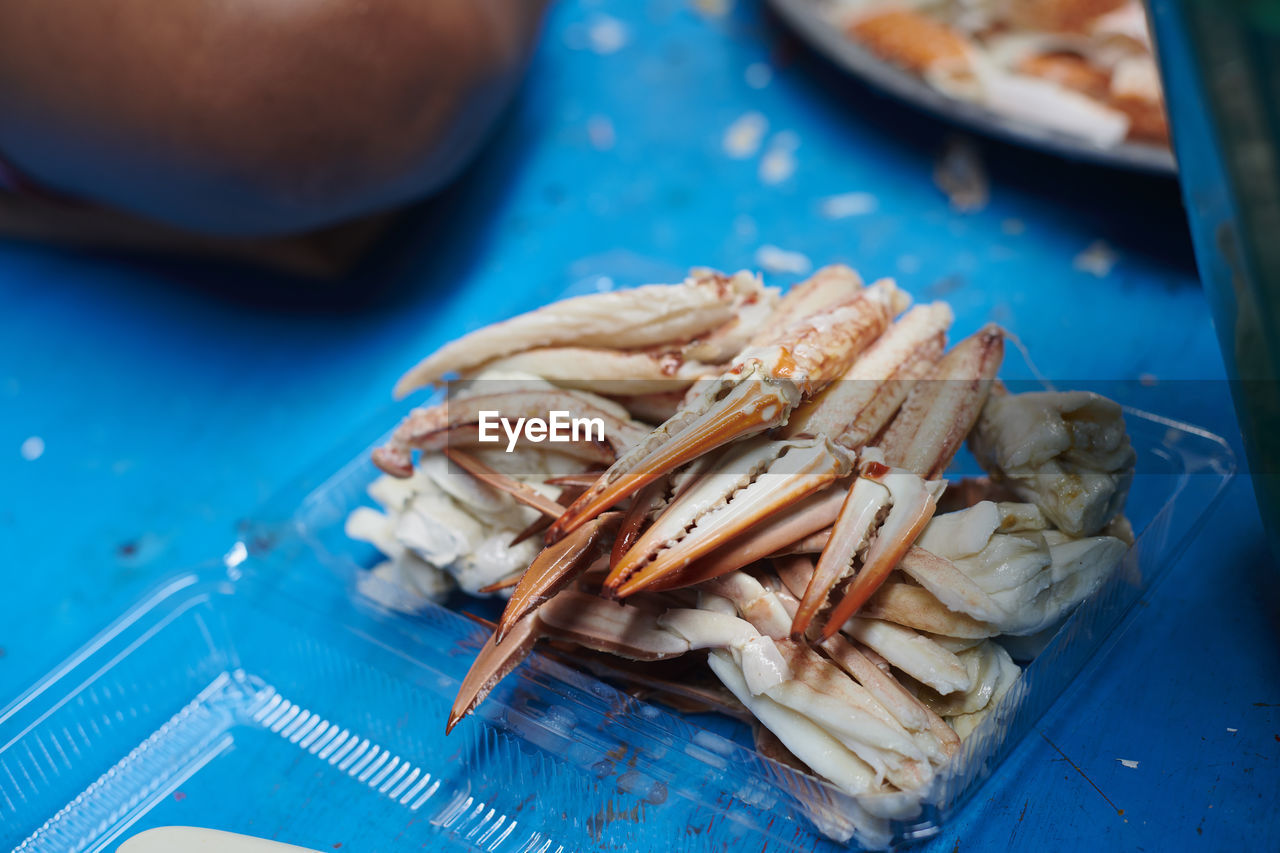 HIGH ANGLE VIEW OF SEAFOOD IN CONTAINER ON TABLE