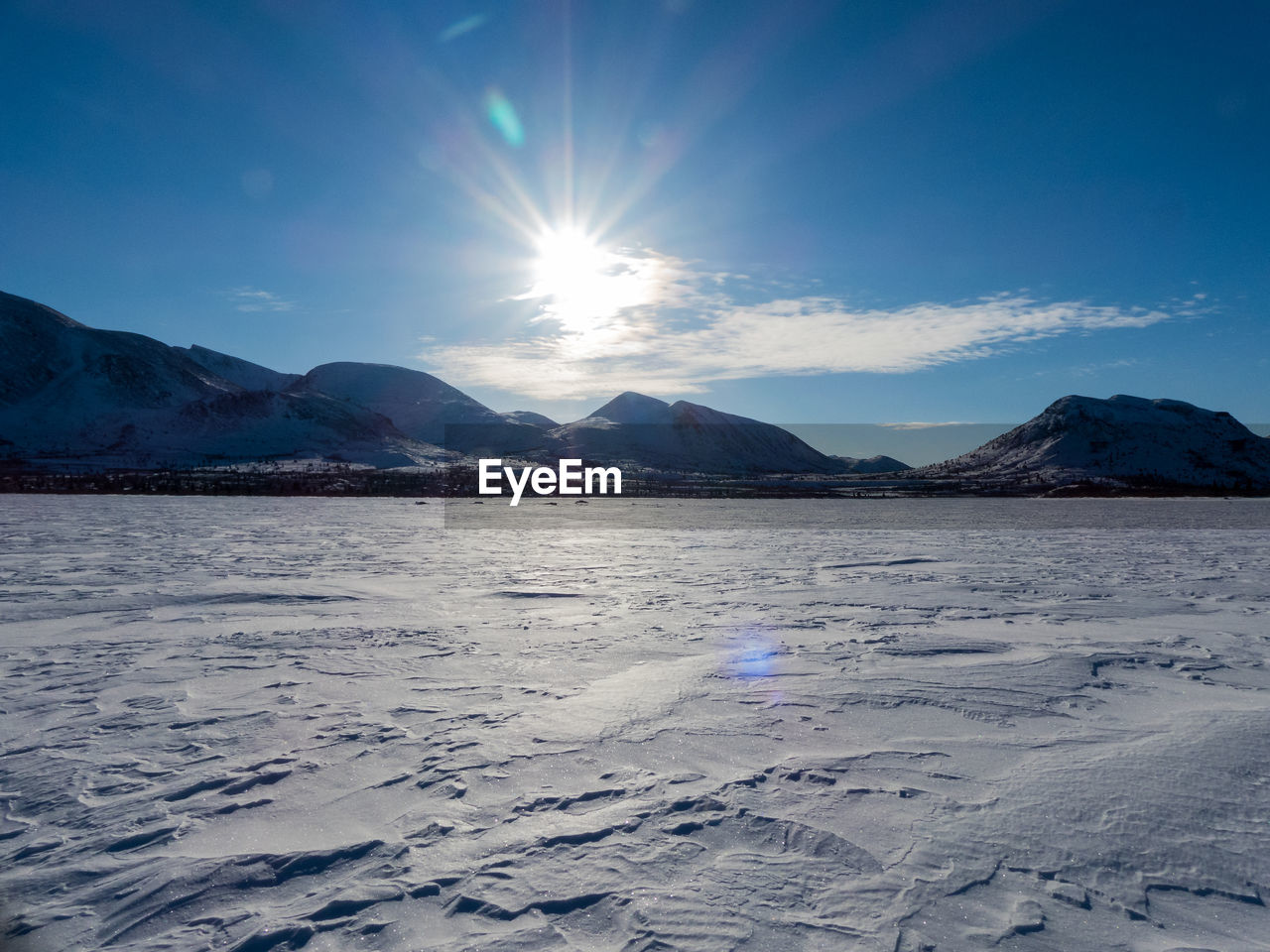 Scenic view of frozen sea against sky at sunset