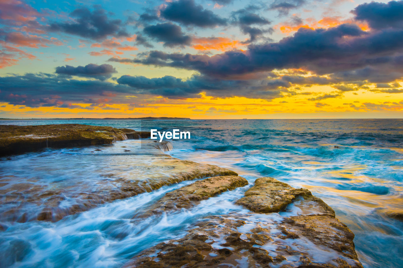 Scenic view of sea against sky during sunset