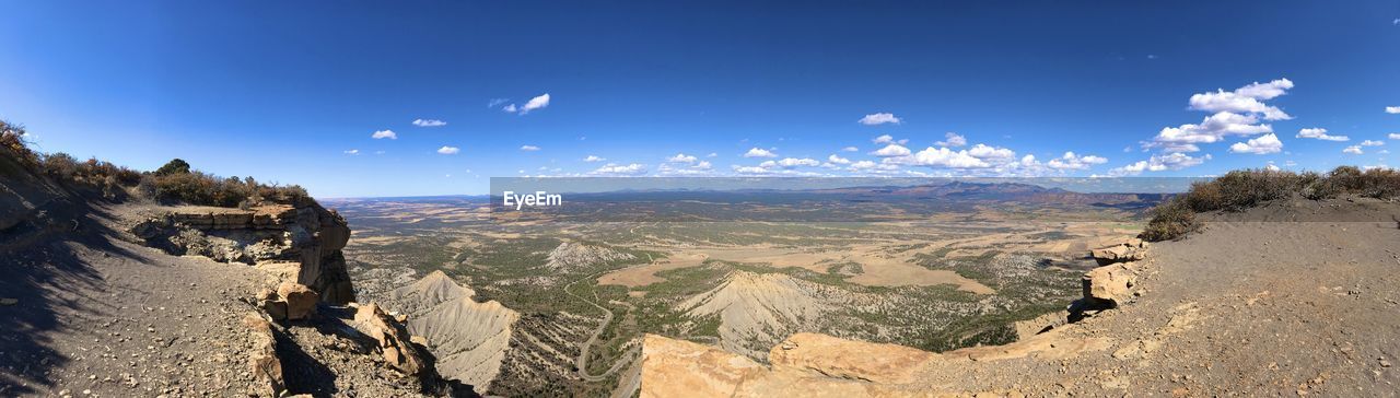 Panoramic view of landscape against blue sky