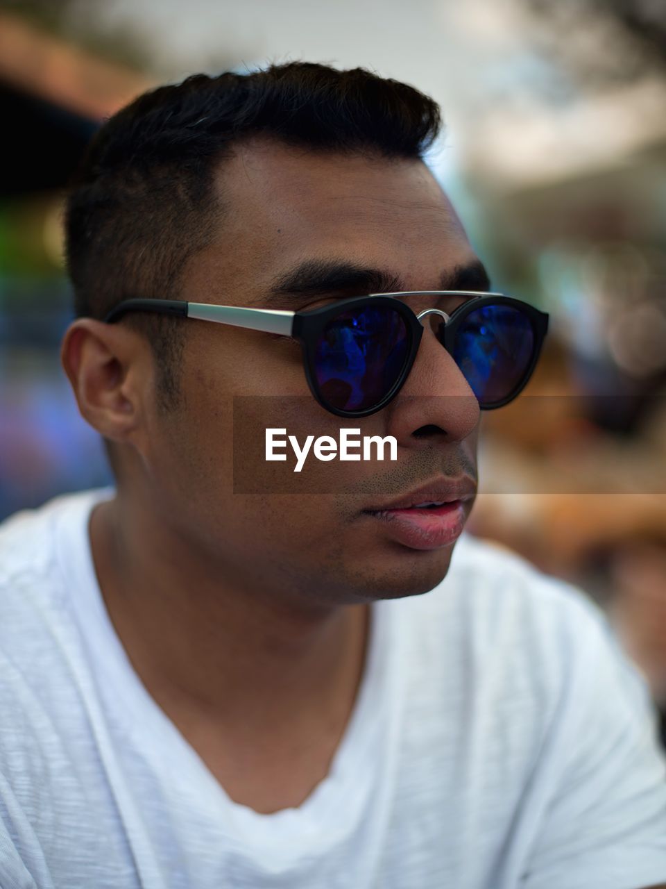 Close-up of man wearing sunglasses looking away