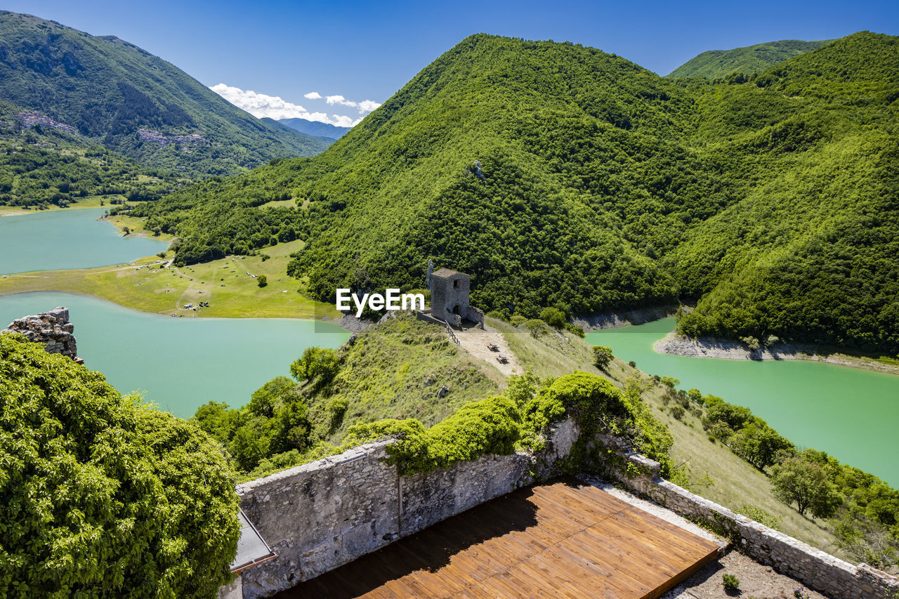 high angle view of townscape by mountains against sky