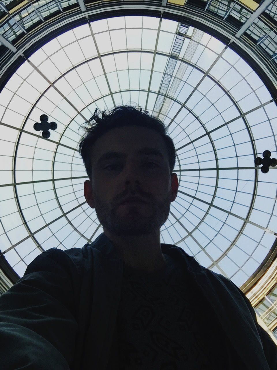 Portrait of man against skylight at berlin ostbahnhof