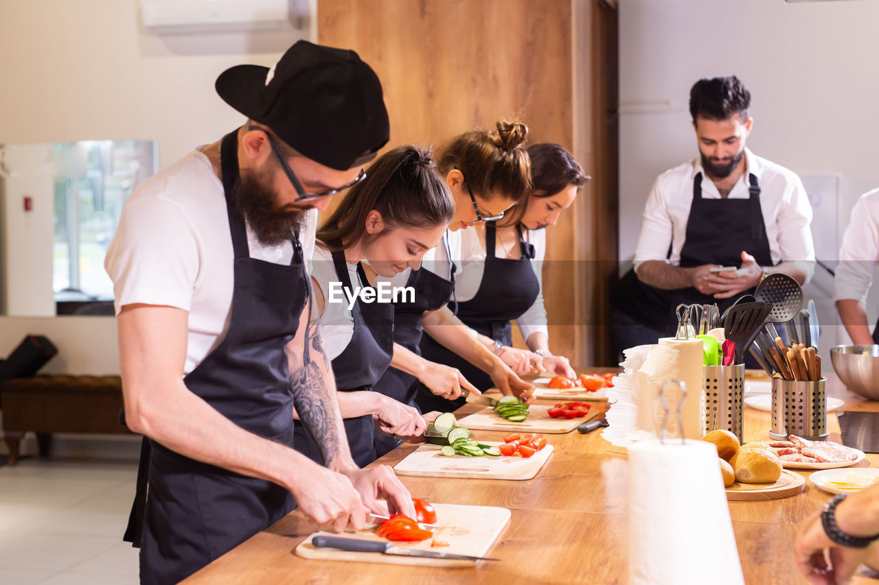 side view of friends working at table