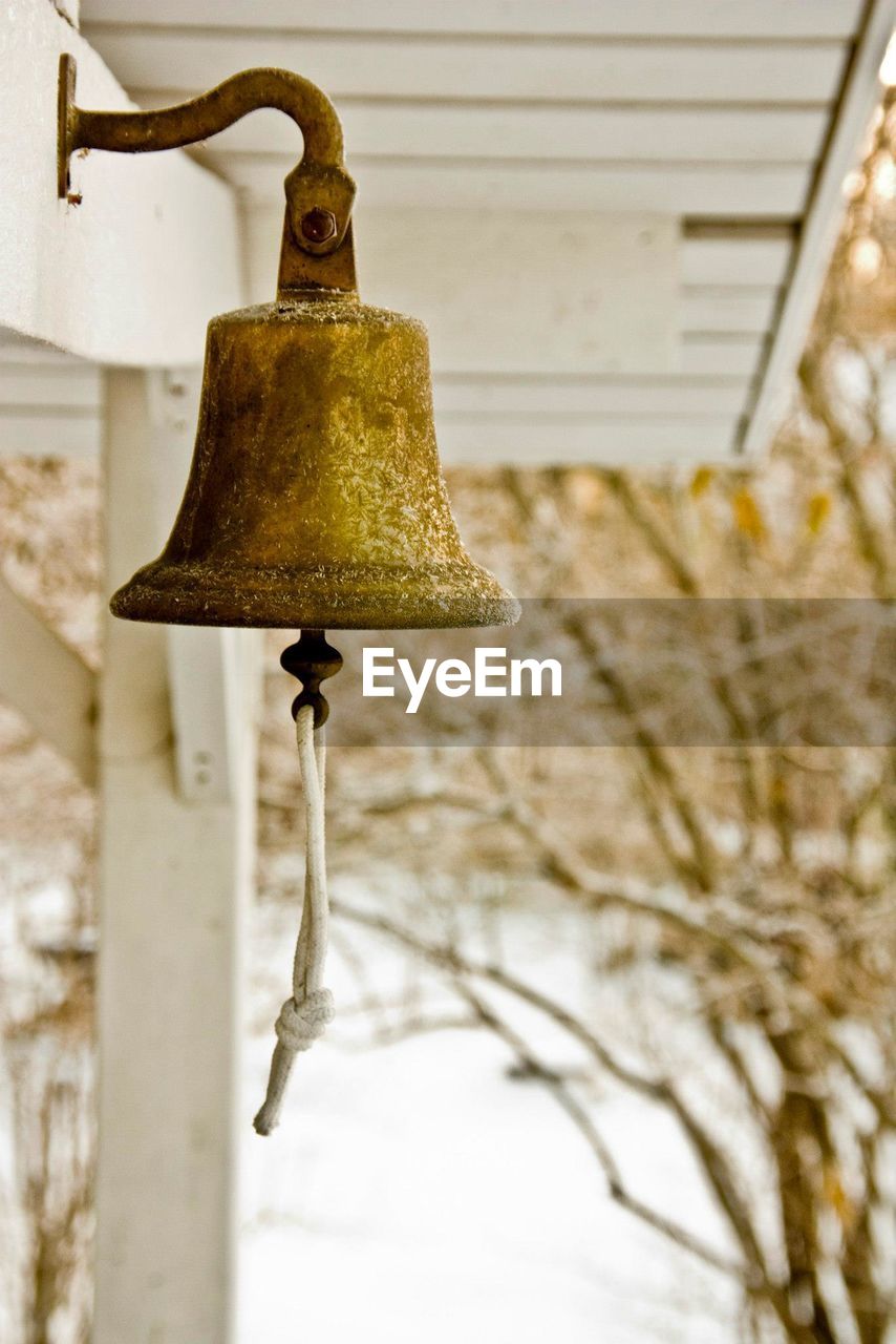 Close-up of old metallic bell at entrance