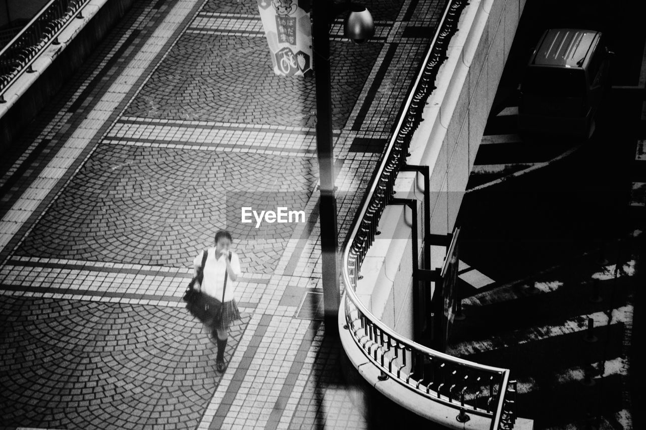 High angle view of woman walking on bridge