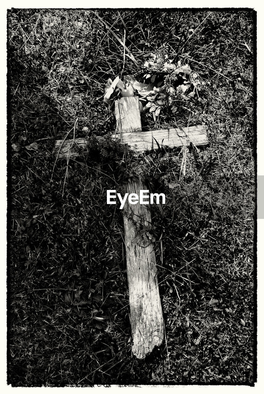 High angle view of cross on grassy field