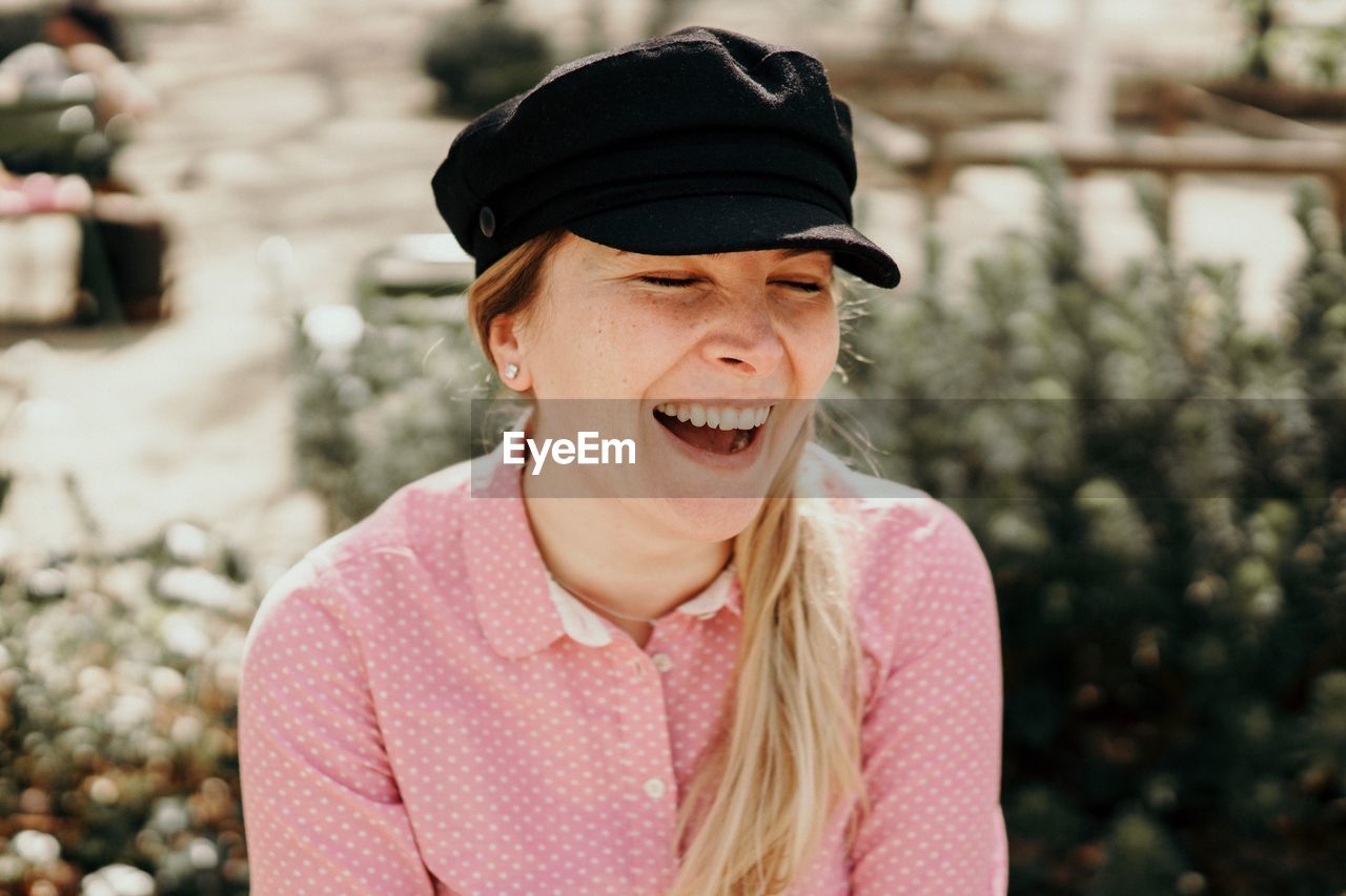 Close-up of smiling woman wearing cap