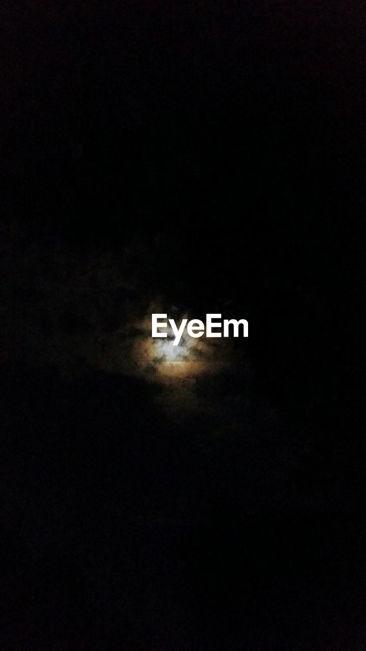 LOW ANGLE VIEW OF MOON IN SKY AT NIGHT