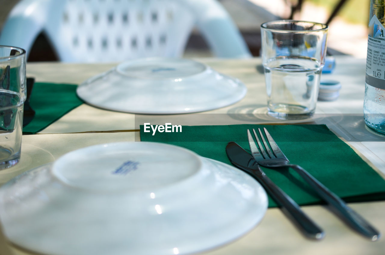 Close-up of glasses on table in restaurant