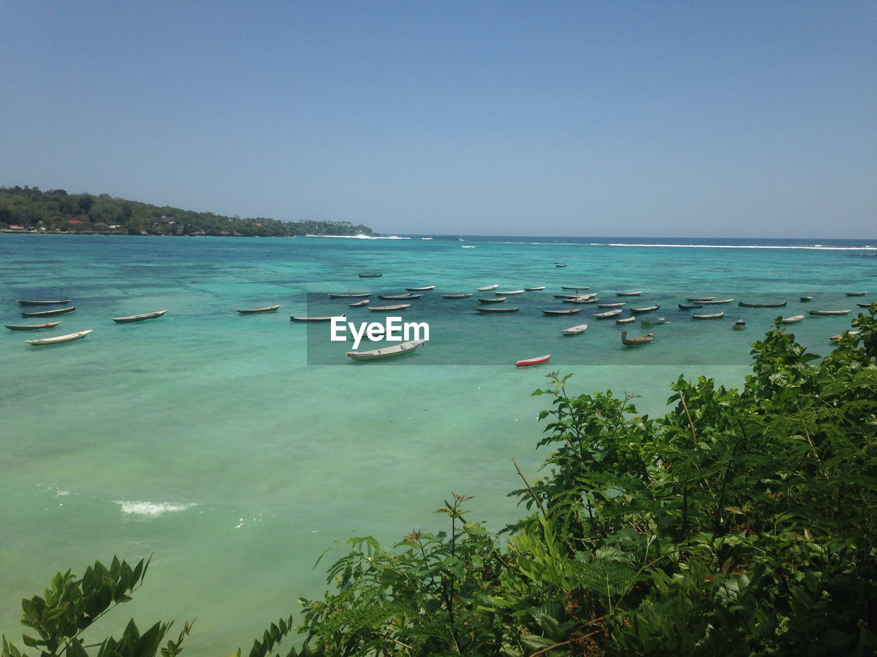 Scenic view of sea against clear blue sky