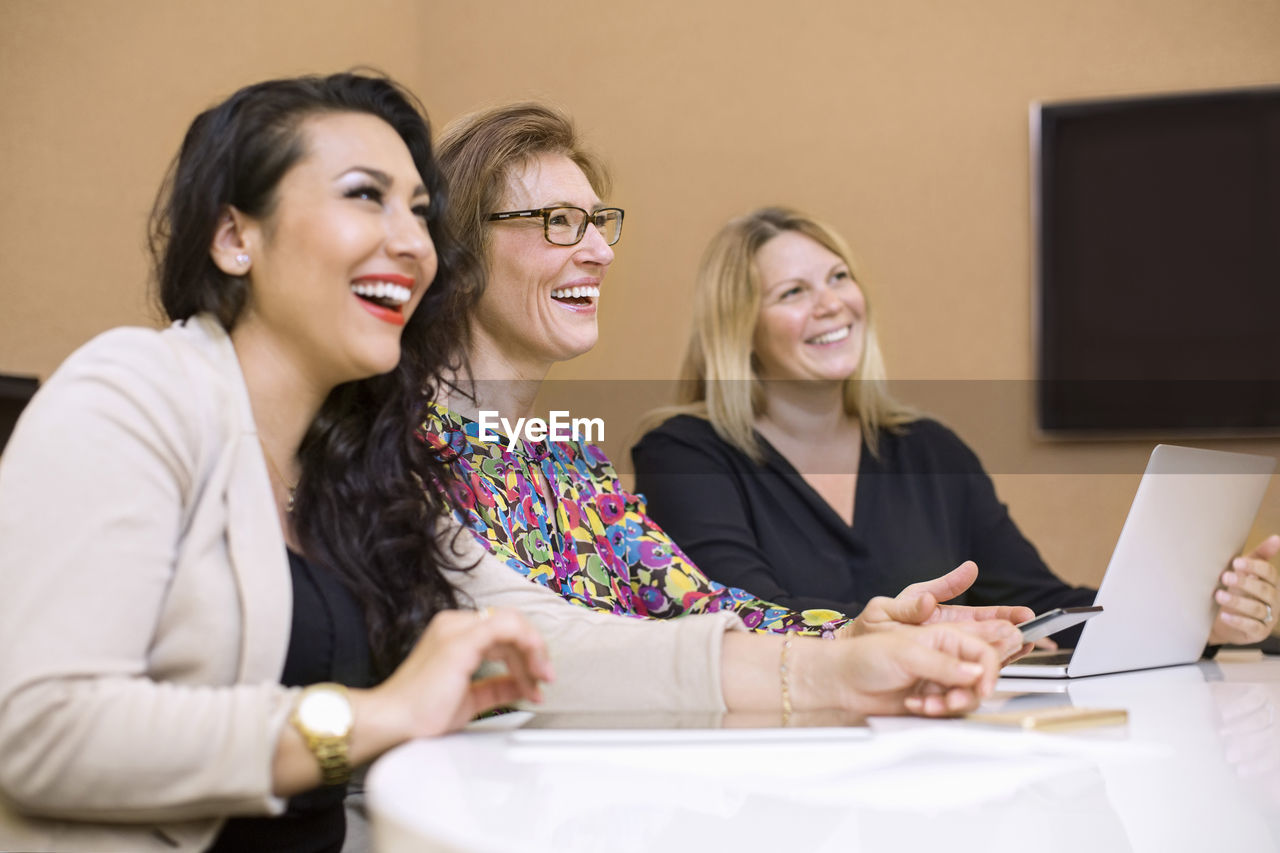 Happy businesswomen in meeting at board room in creative office