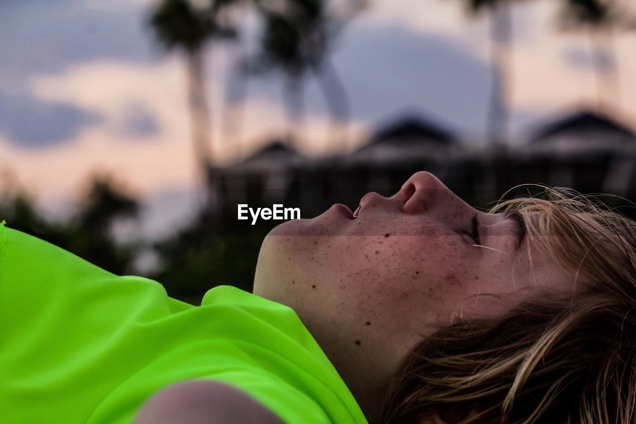 Close-up of boy lying outdoors