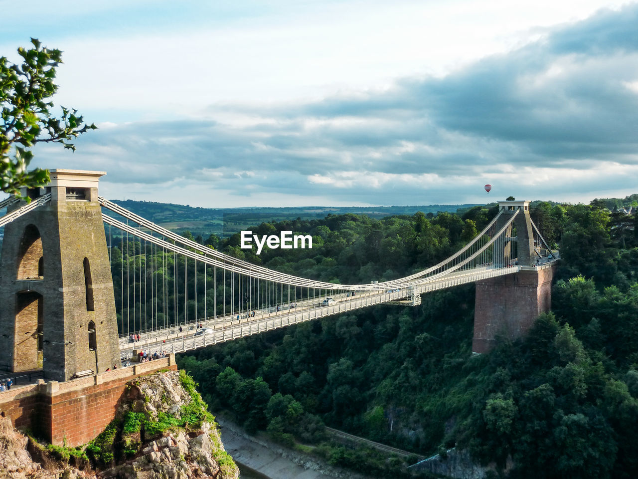 Bridge over river against cloudy sky