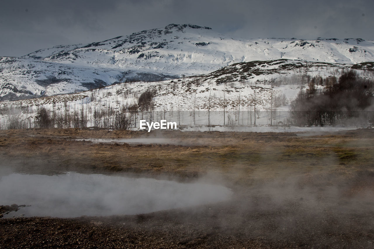Smoke emerging from volcanic landscape