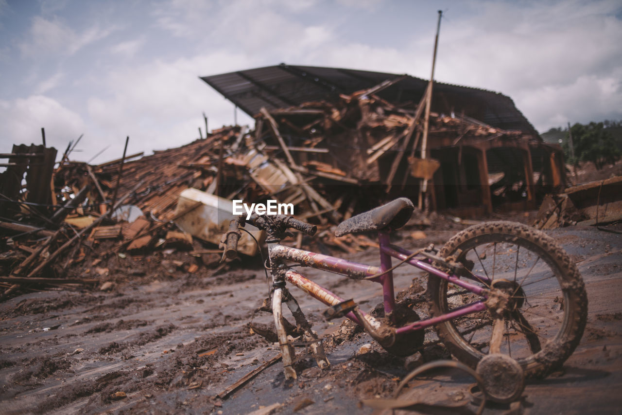 Damaged bicycle and houses by tsunami