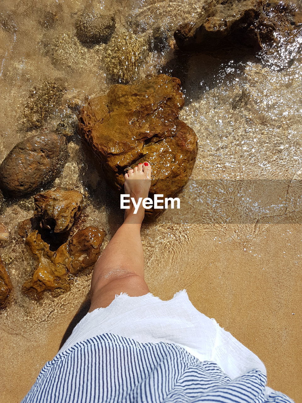 one person, water, real people, low section, human leg, lifestyles, sea, high angle view, leisure activity, barefoot, body part, nature, human body part, personal perspective, beach, human foot, adult, relaxation