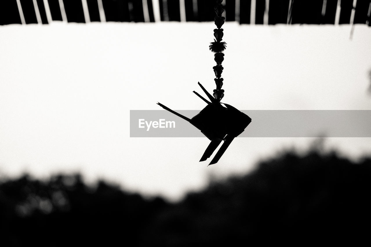 Close-up of decoration hanging against sky