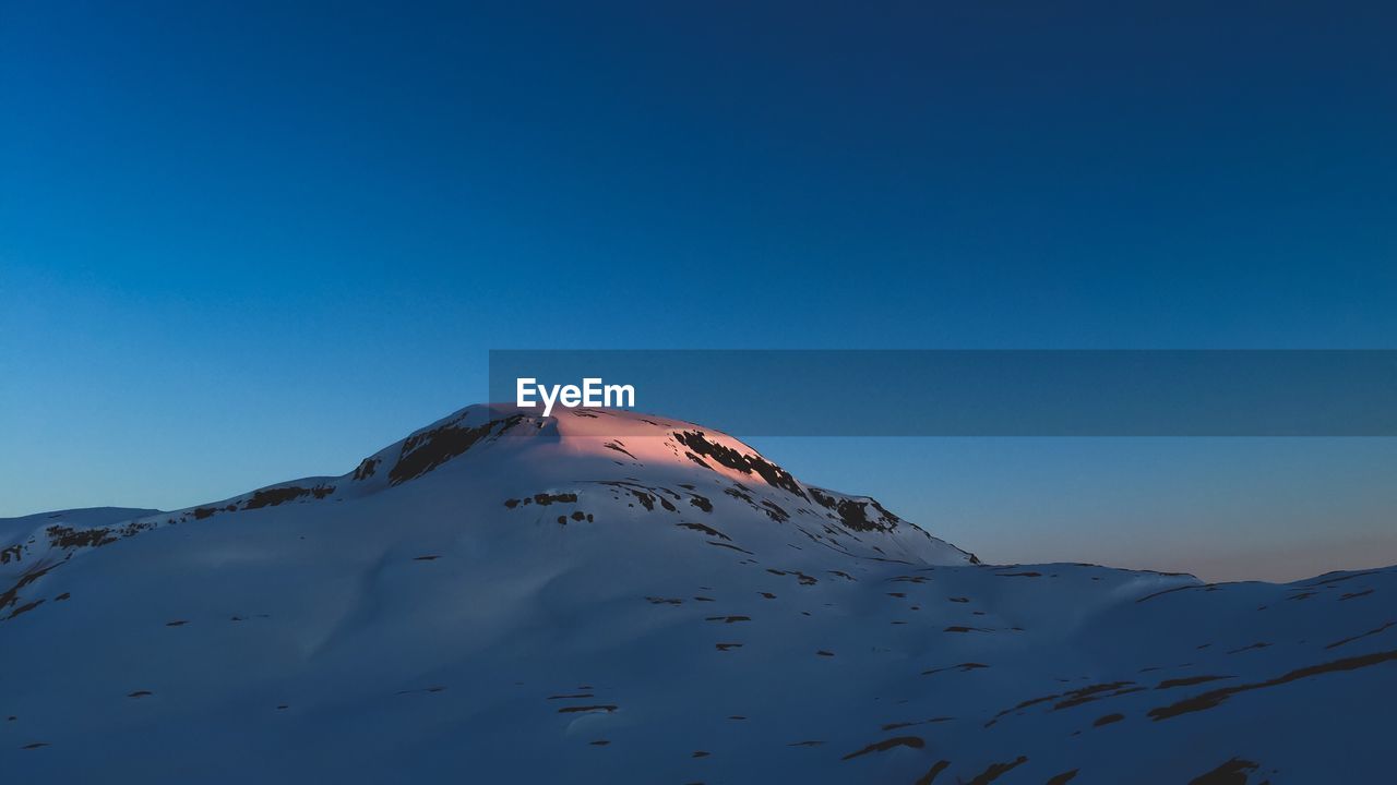 Scenic view of landscape against clear blue sky