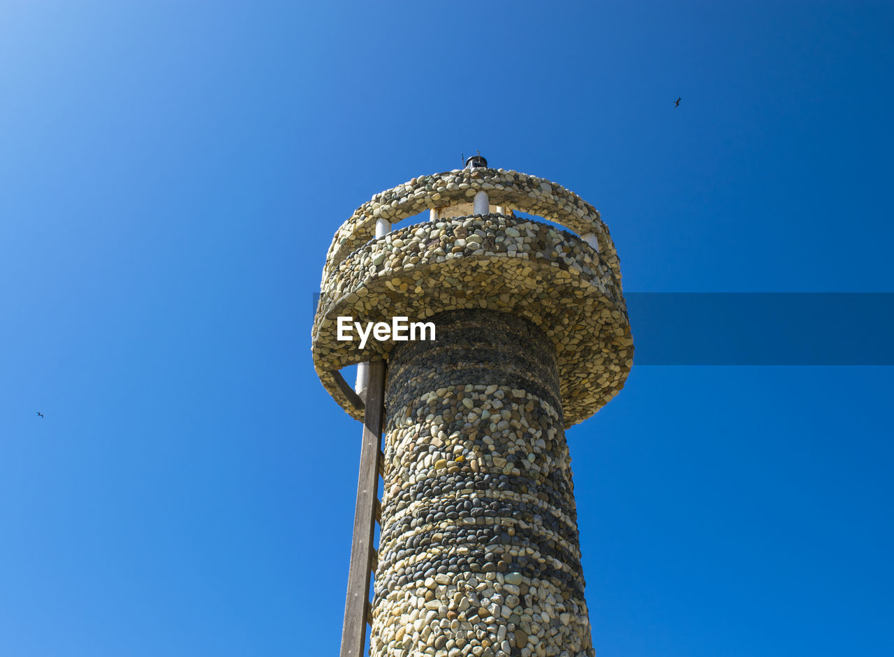 Low angle view of tower against clear blue sky