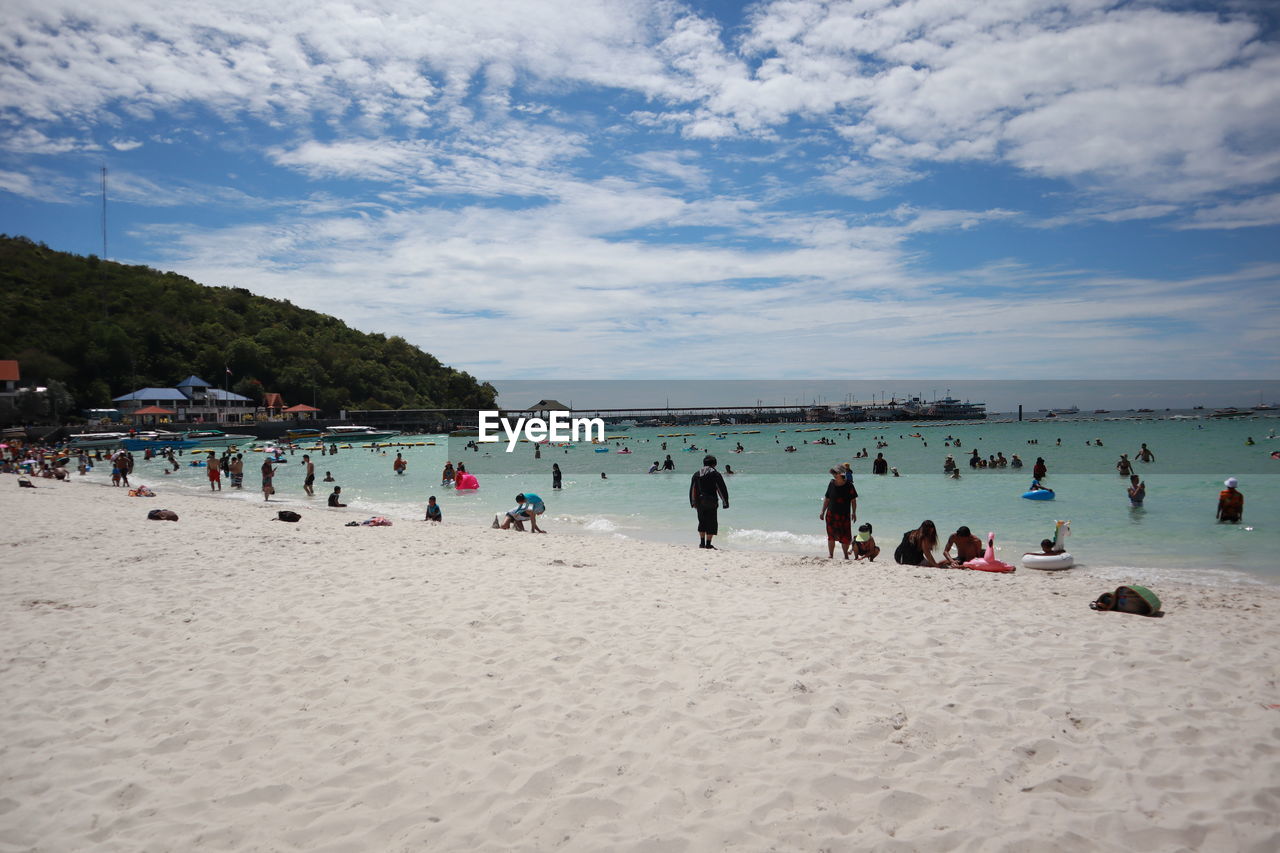 PEOPLE AT BEACH AGAINST SKY