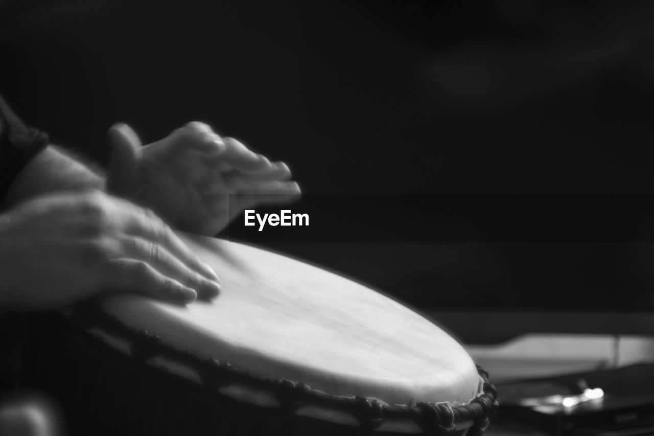 Close-up of hands playing a drum