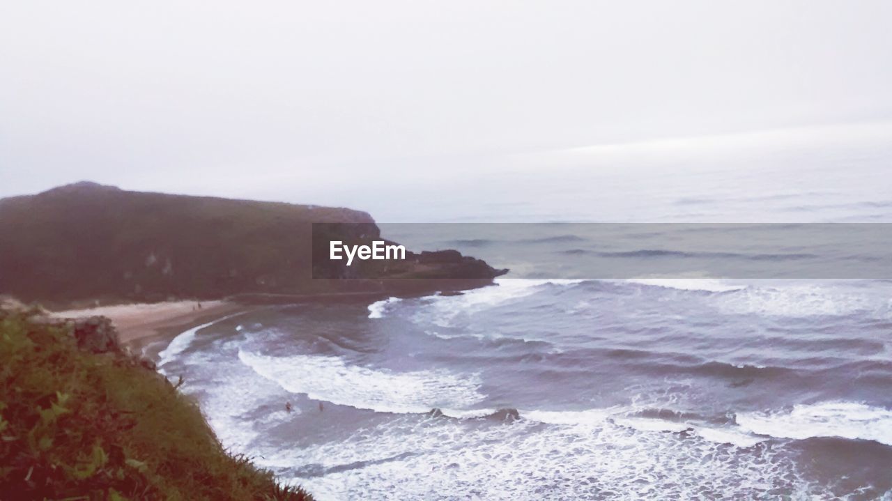 SCENIC VIEW OF SEA AND ROCKS AGAINST SKY