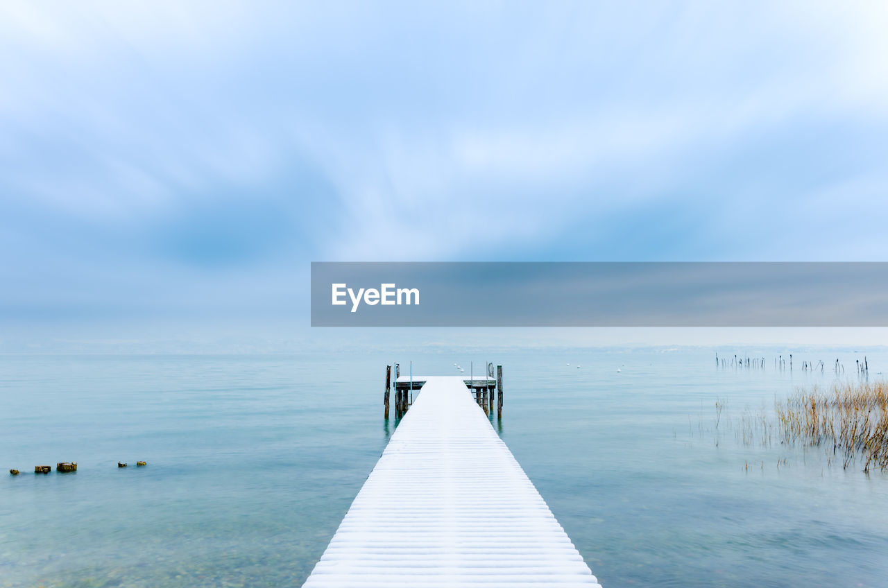 Pier over sea against sky