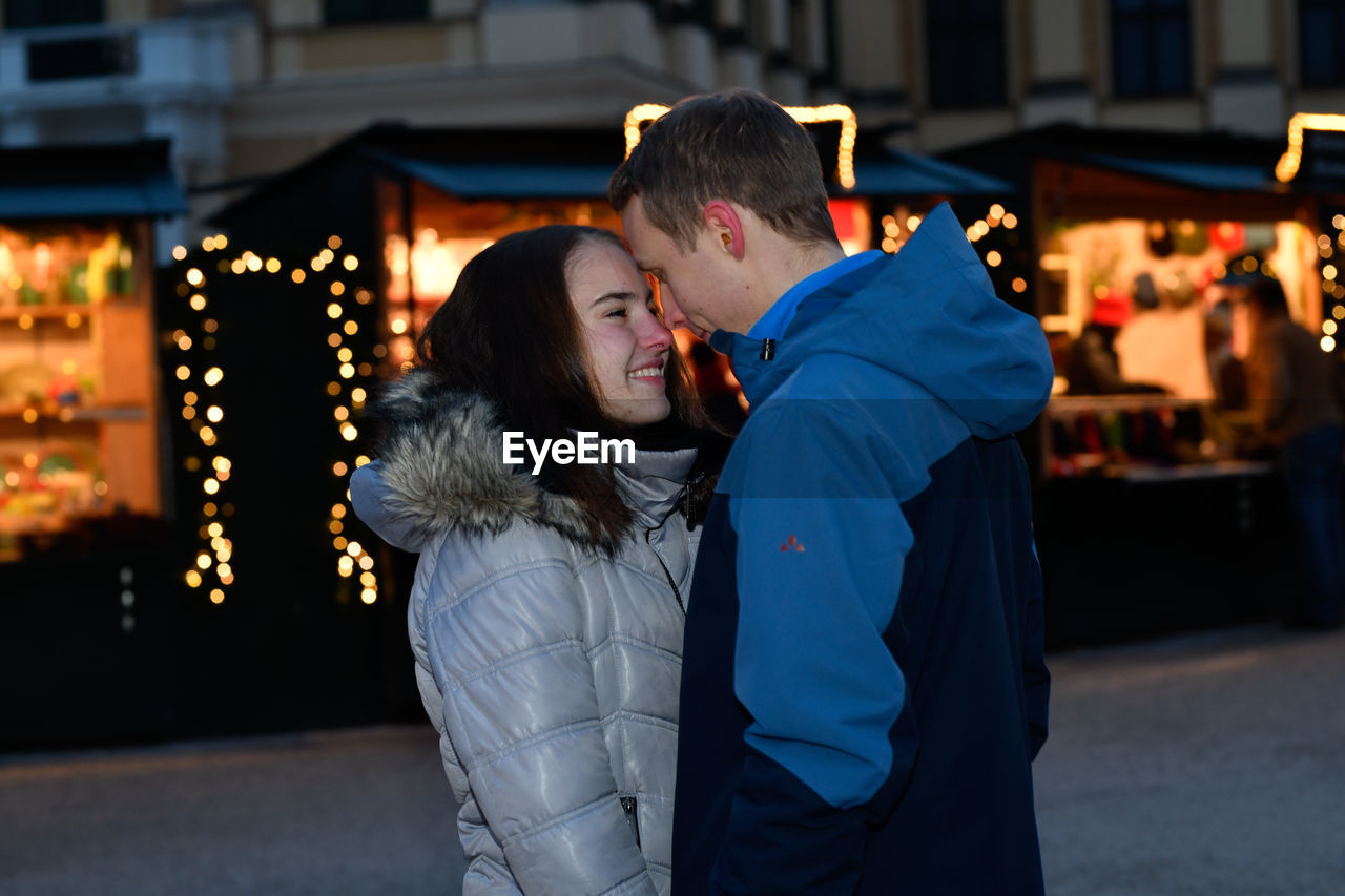 Young couple teasing each other at the christmas market.