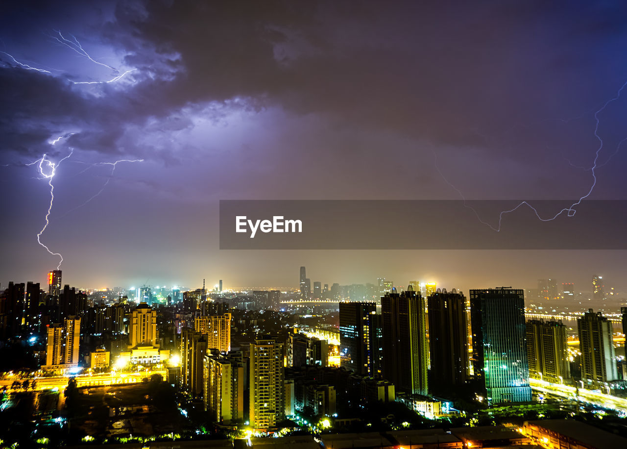 Panoramic view of illuminated city against sky at night