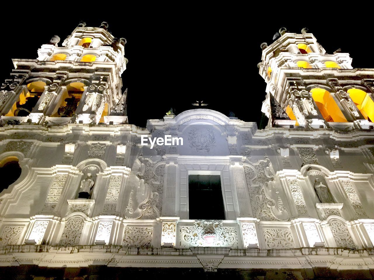 Low angle view of illuminated puebla cathedral at night