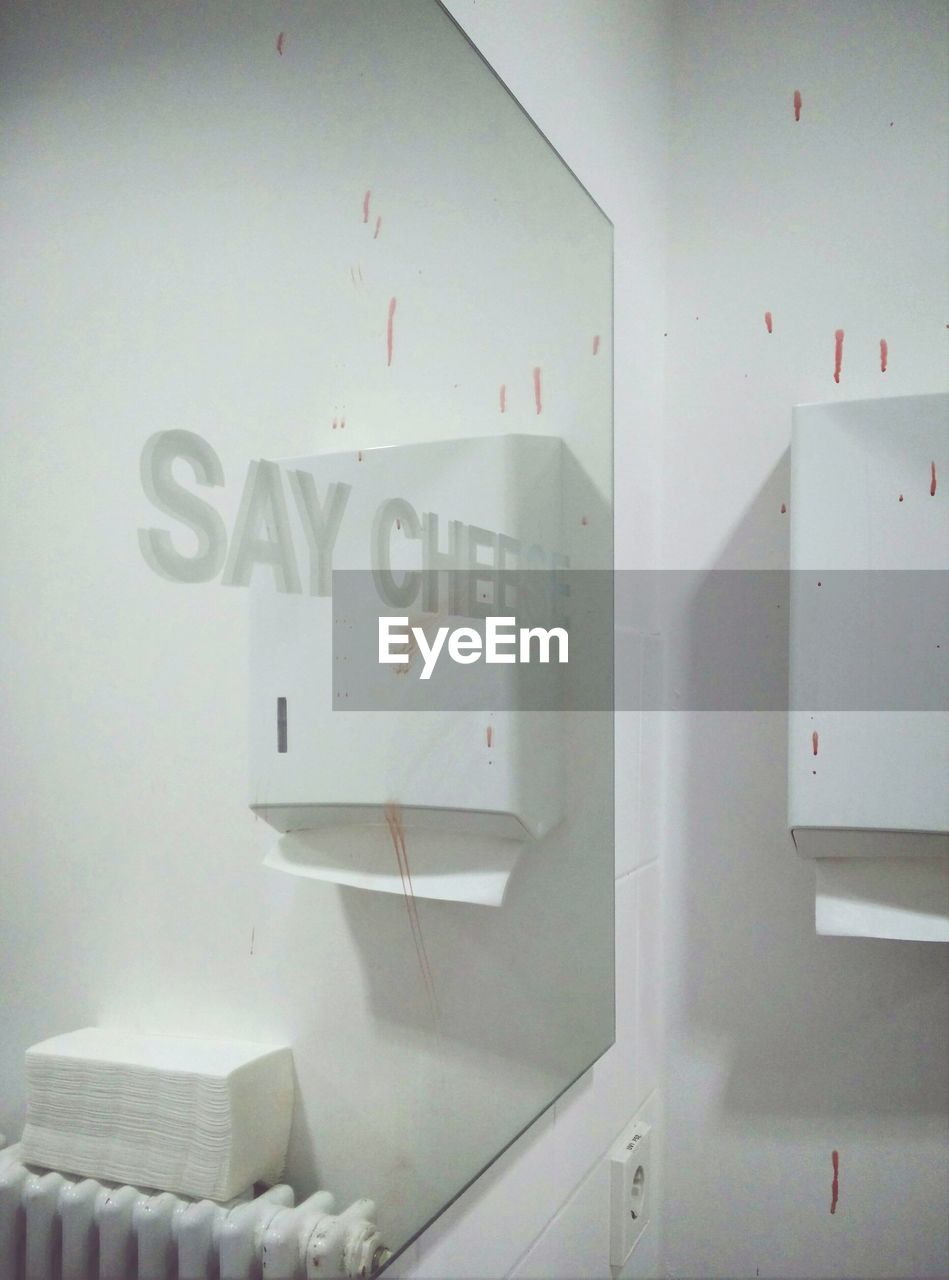 Say cheese text on mirror in bathroom