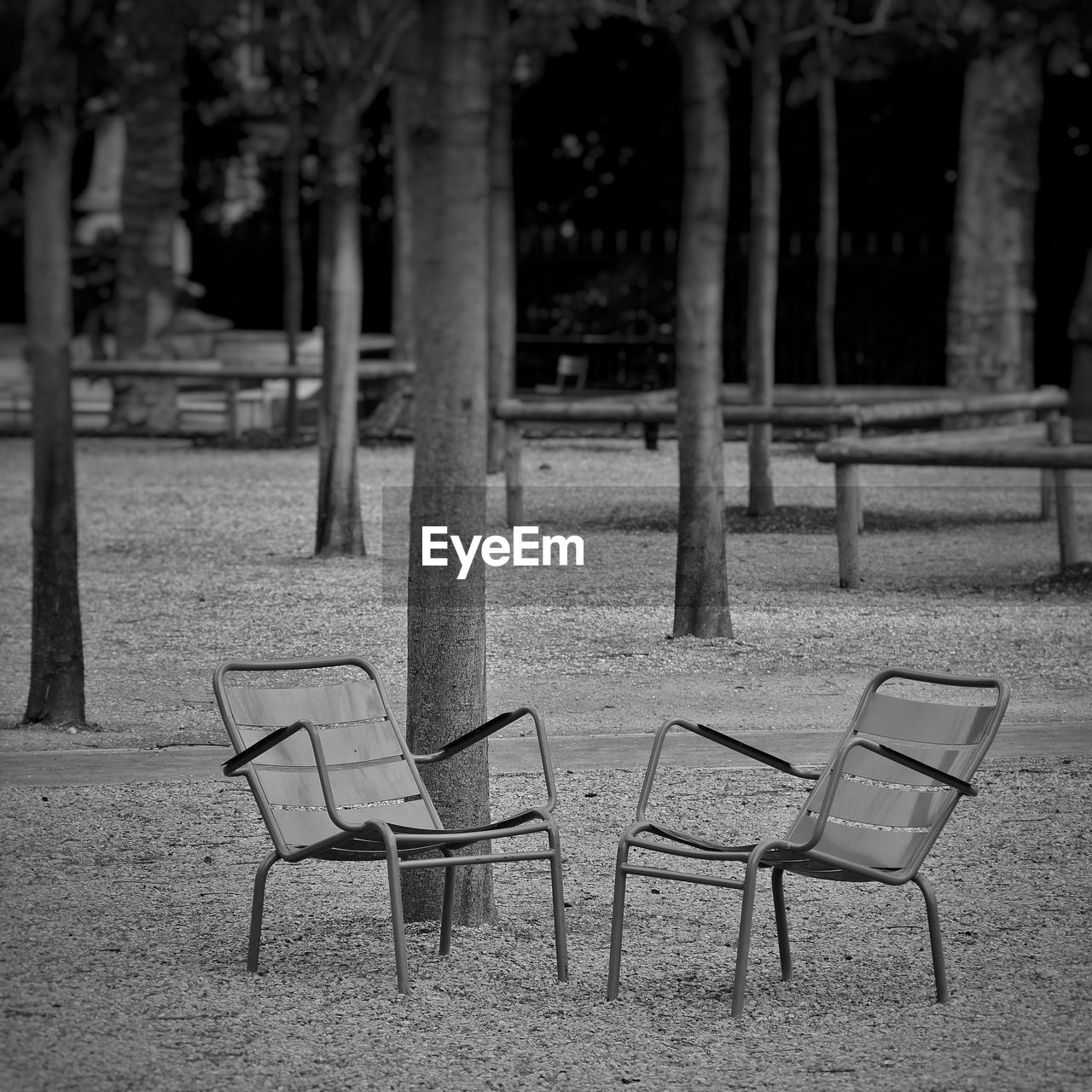 EMPTY CHAIRS AND TABLES IN PARK
