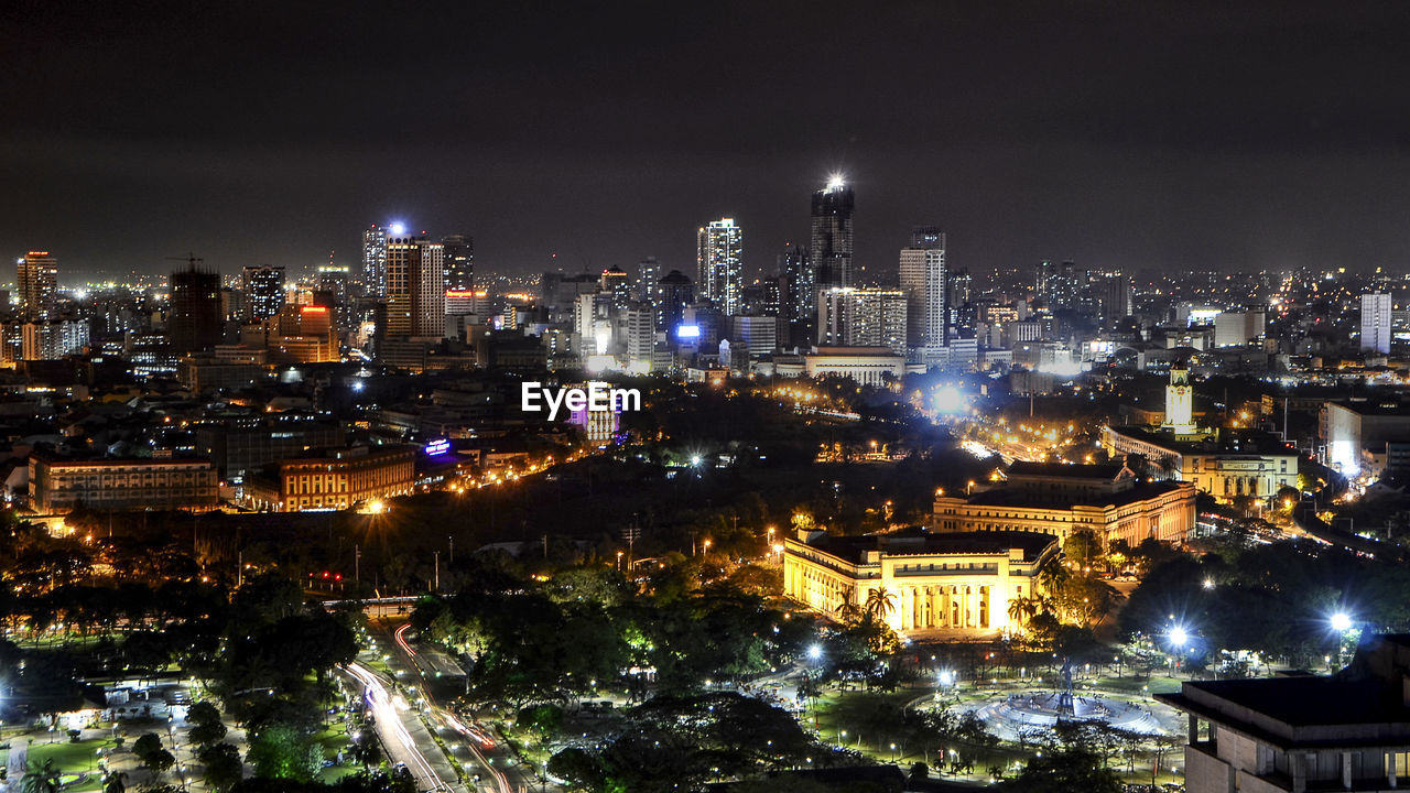 Aerial view of city lit up at night