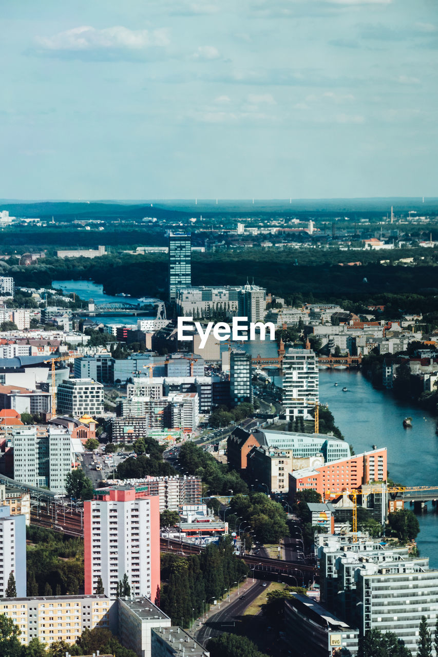 High angle view of cityscape by sea against sky