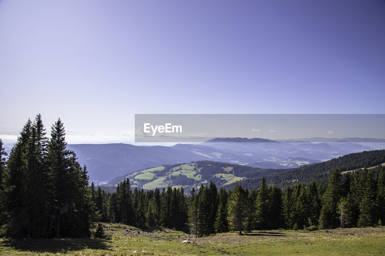 Scenic view of mountains against clear blue sky