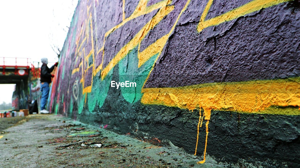 CLOSE-UP OF MULTI COLORED BUILT STRUCTURE AGAINST SKY