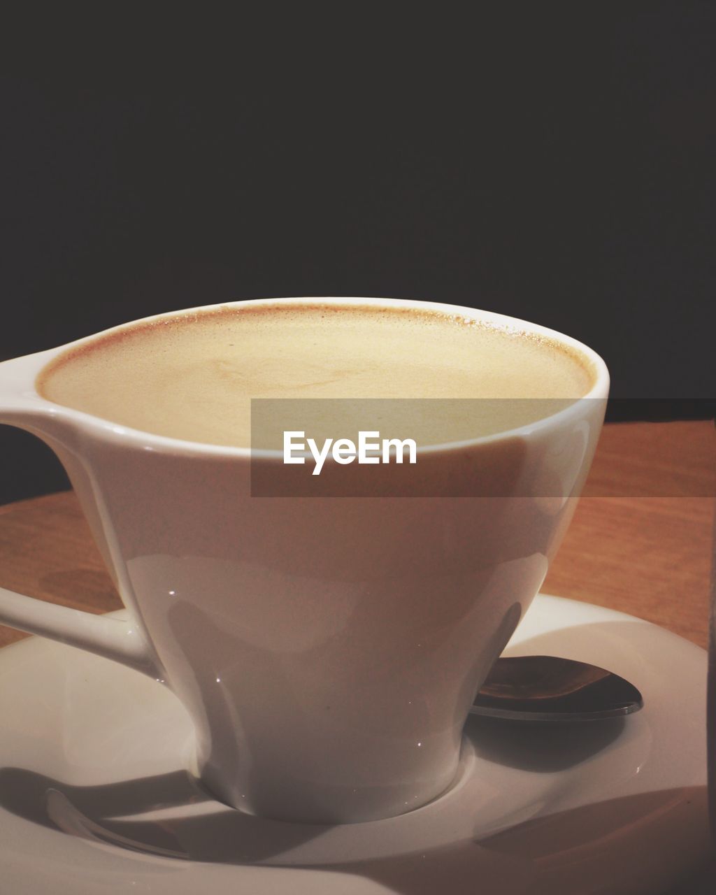 Close-up of coffee cup served on table