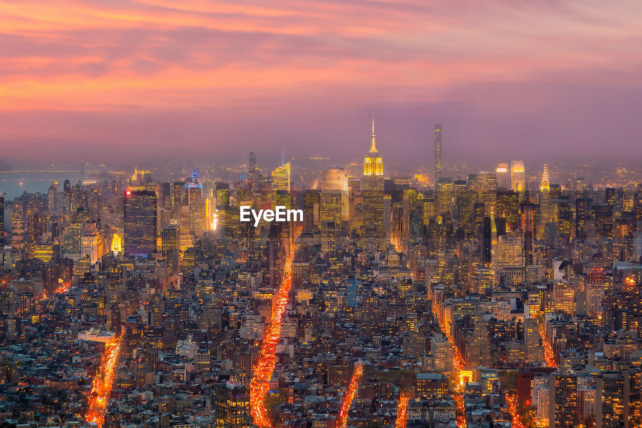 high angle view of illuminated cityscape against sky at night