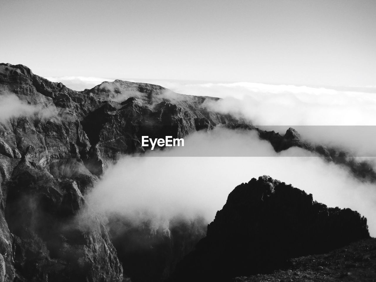 Scenic view of mountains against cloudy sky