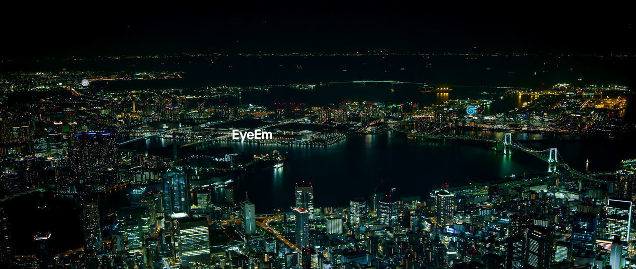 High angle view of illuminated city buildings at night