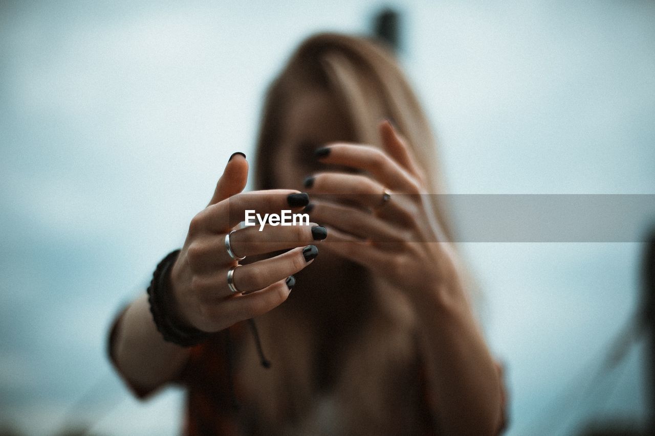 Close-up of woman hands with black nail polish