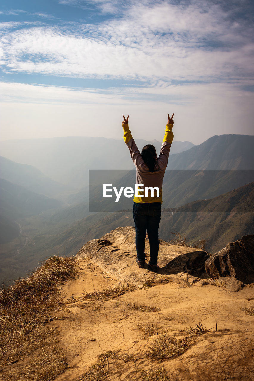 Full length rear view of man standing on mountain